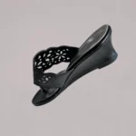Side profile of women’s wedge shoes with a sleek slip-on silhouette and elevated sole